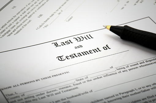 Last Will and Testament estate planning document with a ballpoint pen.