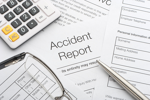 accident report with pen and calculator