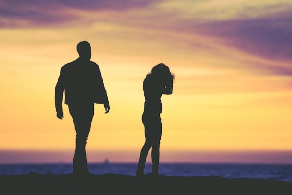 A frustrated couple on the beach on the brink of a divorce.